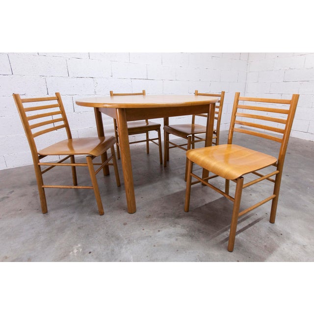Modernist Danish-made dining set comprising a round convertible table and four matching chairs from the 1980s. This set is...
