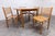 Modernist Danish-made dining set comprising a round convertible table and four matching chairs from the 1980s. This set is...