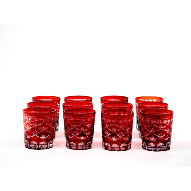 Glassware set of twelve (12) whiskey/scotch tumbler glasses in red-flashed clear glass with fine engraved designs....