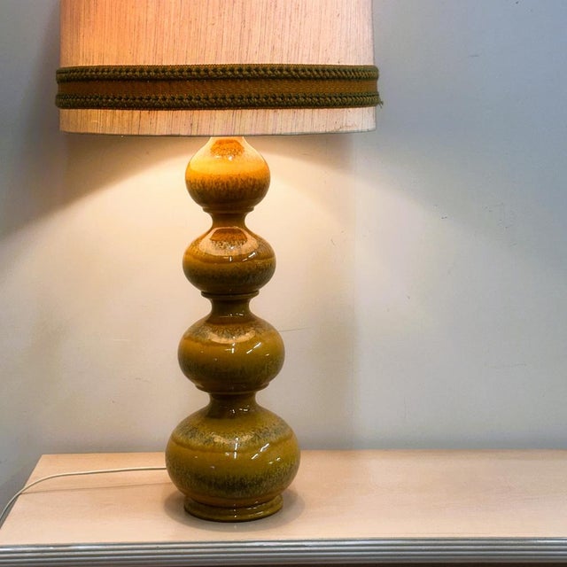A striking 1970s kaiser leuchten lamp in a deep mustard-ochre glaze, featuring a sculptural stacked-sphere ceramic base...