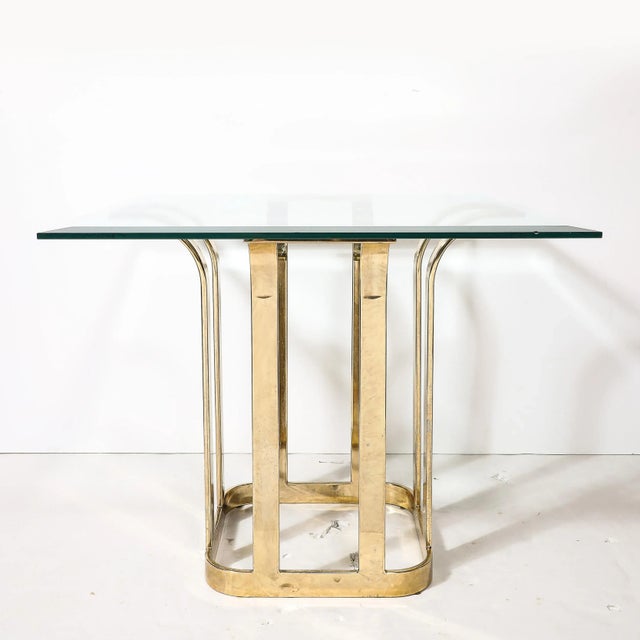 This beautifully formed Mid-Century Modernist Stylized Tulip Form Banded Brass Dining Table W/ Glass Top originates from...