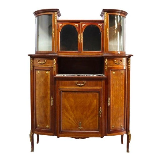 A distinguished pair of antique mahogany credenzas, circa 1890, featuring exquisite parquetry detailing and ornate ormolu...