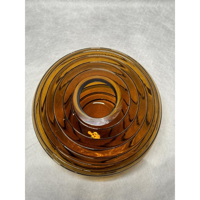 Amber-colored glass vase with a black raised decorative lines in a classic Art Deco style. Likely produced in the Bohemian...
