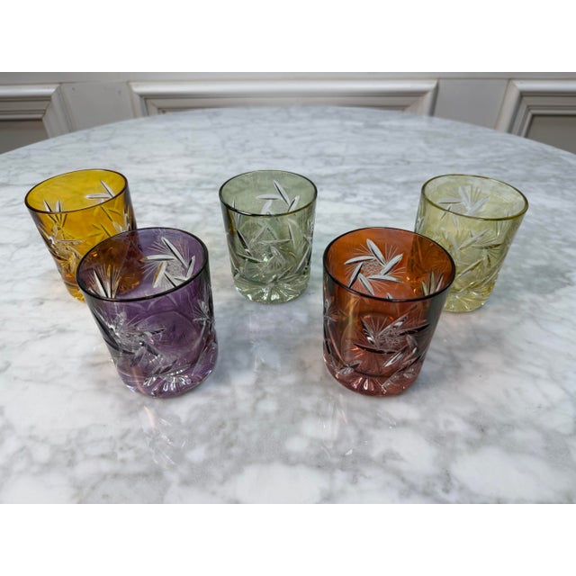 Add a vibrant touch of Japanese craftsmanship to your bar cart with this stunning set of five "cut-to-clear" crystal...