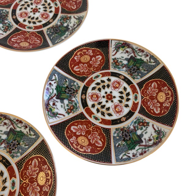 - Set of 4 Imari Japanese plates - Distinctive underglaze blue and over-glazed red and gold decoration - Featuring floral...