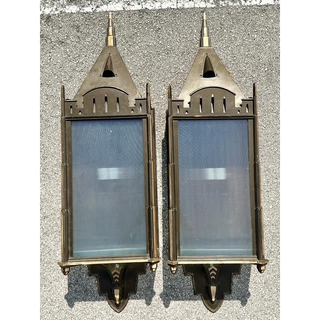 This monumental pair of wall sconces makes a grand architectural statement with a design that masterfully blends Art Deco...