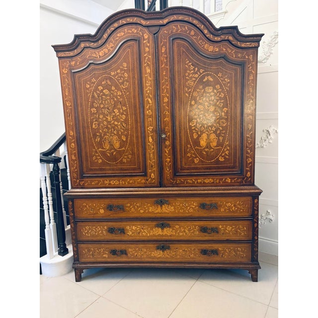 A fine and richly decorated antique Dutch walnut linen press, constructed in the late 18th century and extensively inlaid...
