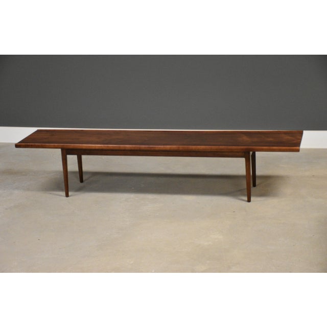 A mid century modern walnut coffee table designed by Kipp Stewart and Stuart MacDougall for Drexel Declaration. Made in...