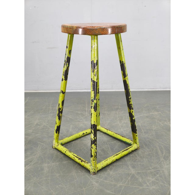 Original industrial stool produced in Czechoslovakia during the 1940s. The piece features a lacquered metal frame with a...