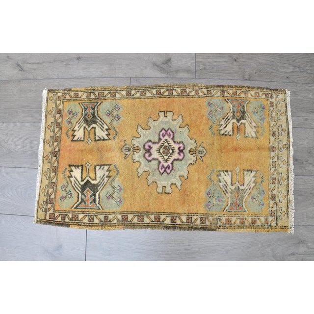 This is a vintage Turkish Oushak rug from the 1960s. The piece was hand-knotted.