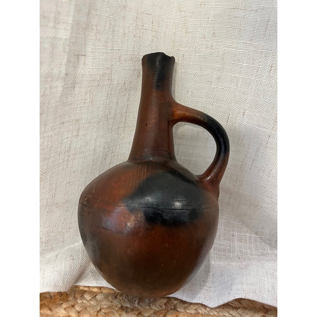 The Antique African Ethiopian Terracotta Jebena Jar is a beautifully crafted piece. Handmade in Ethiopia, this terracotta...