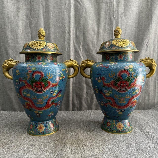 A striking pair of large Chinese Cloisonné Enamel "General Jars." These vibrant vessels feature five-clawed red dragons...