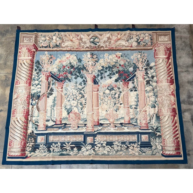 This magnificent vintage tapestry, dating to circa 2000, presents an elaborate classical garden scene defined by...