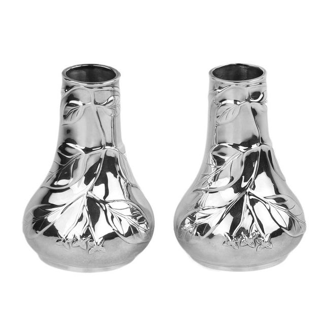 An elegant pair of silver vases from the louis comfort tiffany collection, created in the 20th century. The vases are made...