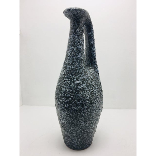 Handmade slender ceramic vase, from 1960's, surface covered with special bluish-black glaze, available in good condition....