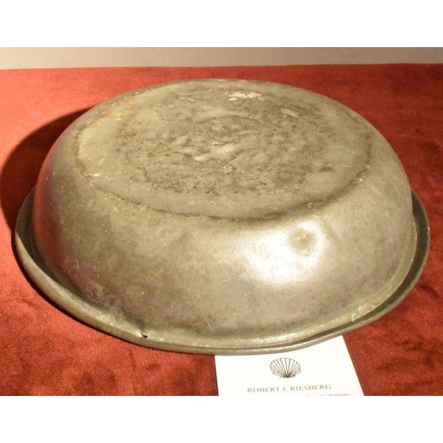 18th century pewter basin with folded rim, well patinaed old surface. There is a later small hole in the rim for hanging...