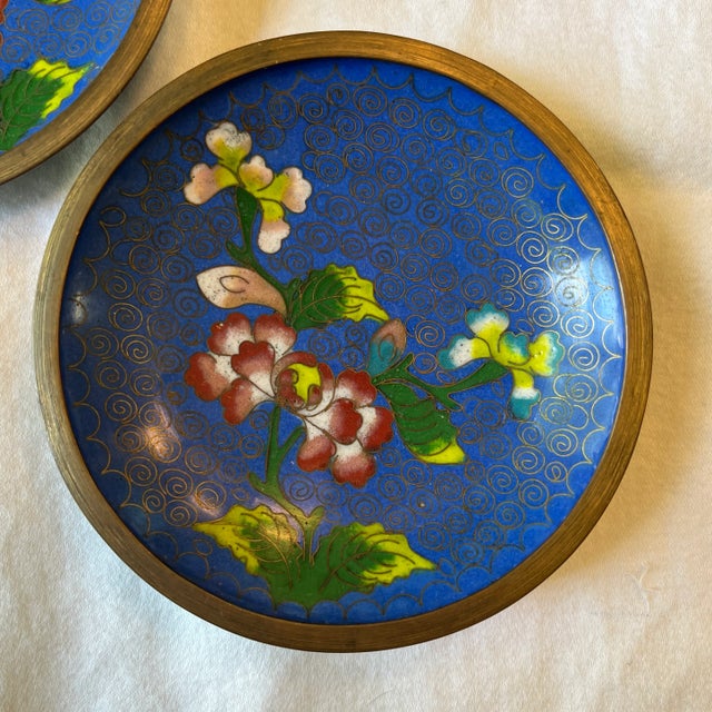 Lovely pair of vintage cloisonné dishes with a deep blue enamel surface and floral pattern.