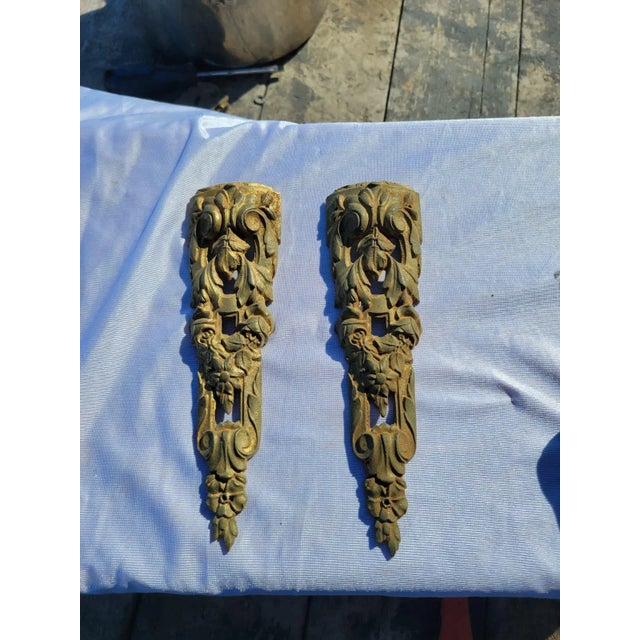 This pair of 19th Century French ormolu bronze mounts features finely detailed floral and scroll designs with remnants of...