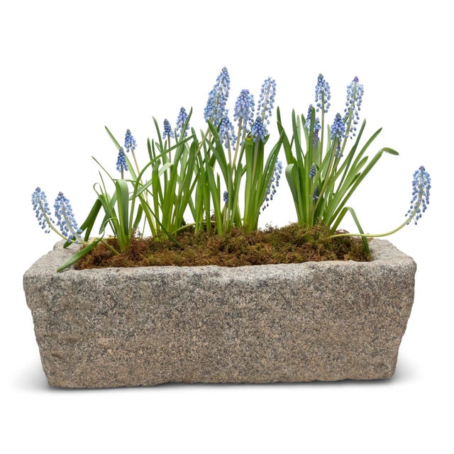 Once a common sight in courtyards throughout rural China, this textured stone vessel was used as a grain or water trough...