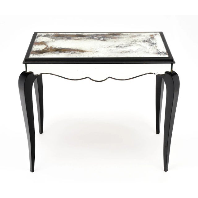 French Art Deco period coffee table, strongly attributed to Dominique, in Vintaged mirrored glass with an ebonized and...