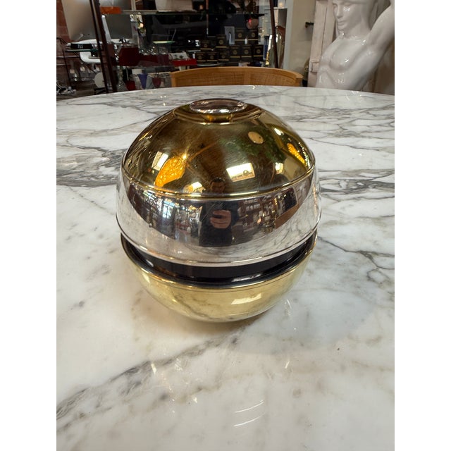 Elegant vintage champagne or wine cooler featuring a polished silver-plated exterior with a removable amber glass liner...
