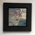 This oil painting on panel presents a close-up portrait that captures a contemplative expression, merging the figure's...