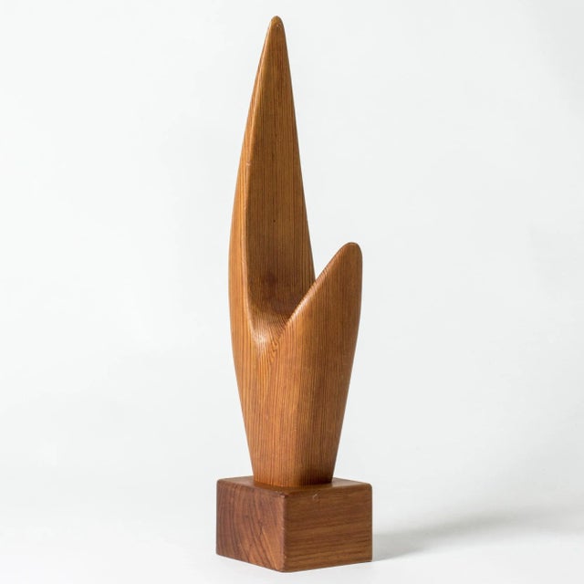 Striking wooden sculpture by Johnny Mattsson, in an abstract form. Pine on a teak base. The form of the sculpture follows...