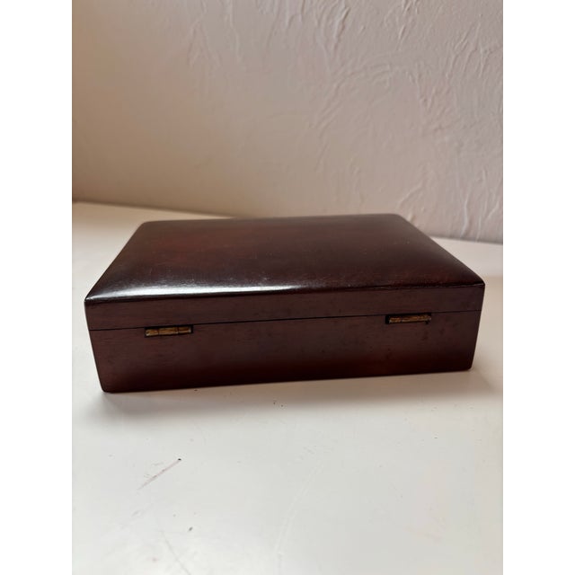 A quietly refined early 20th century English trinket box, notable for its deep, richly toned wood and unfussy, well-...