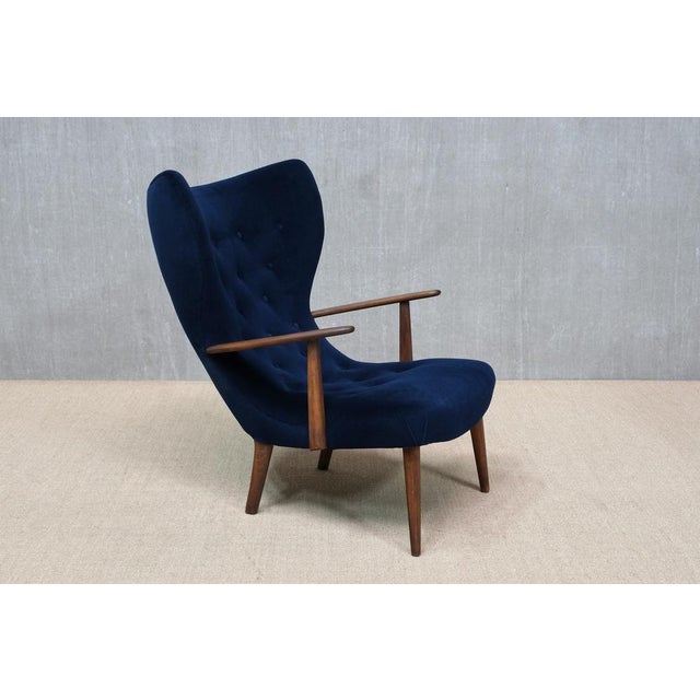 This rare wingback chair was designed by Arnold Madsen & Henry Schubell and produced in Denmark in the 1950s. The model is...