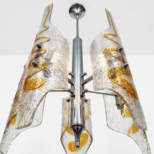 Elegant Murano glass chandelier attributed to Mazzega, composed of vertically arranged tubular elements in clear and amber...