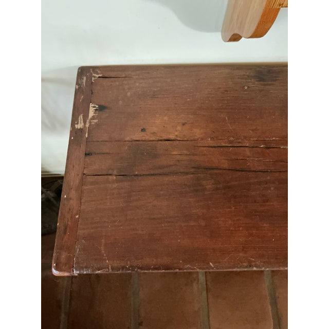 A beautifully rustic farmhouse console table crafted from solid wood, featuring a rich, dark stained finish and a warm,...