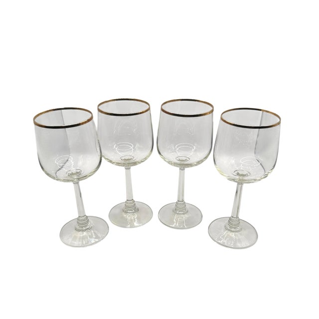 Add timeless elegance to your table setting with this set of four water goblets. Goblets feature a clear glass body...