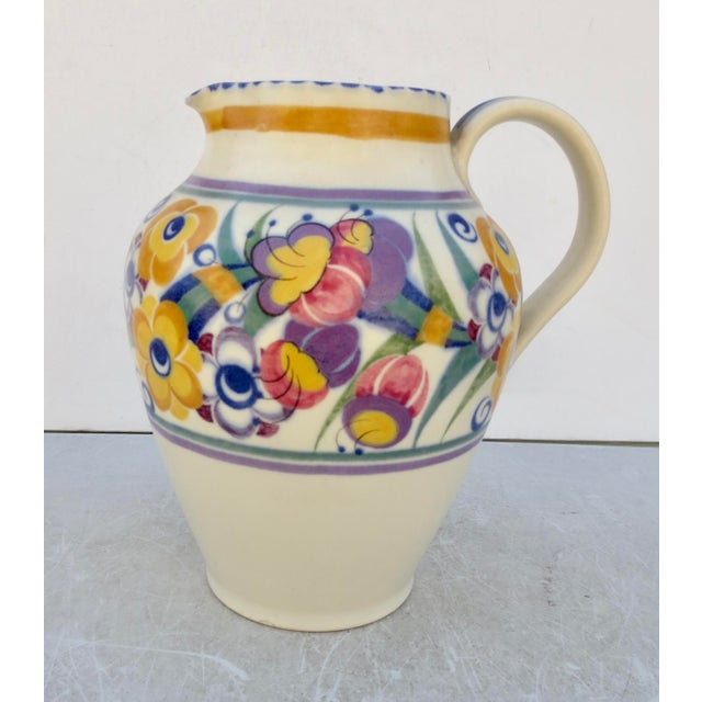 Classic Poole pottery from England, circa 30s. Tall spouted pitcher with handle. The measurements are 8.25" tall and 8"...
