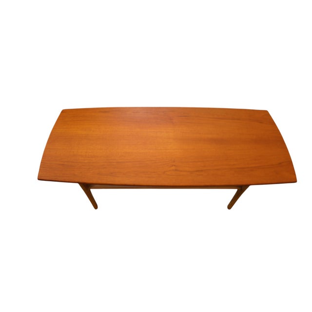 Elegant Danish coffee table with a neat shape and a period-typical Scandinavian design. The table combines a slender table...
