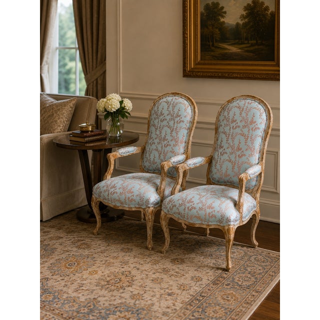 A pair of custom built French country chairs with a floral pattern from Design Center of the Americas (DCOTA). The fabric...