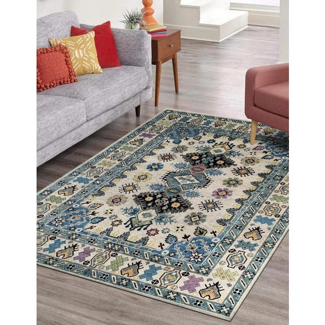 This hand knotted pile rug features a primary color palette of ivory, beige, cream, and white. Made from wool, it offers a...