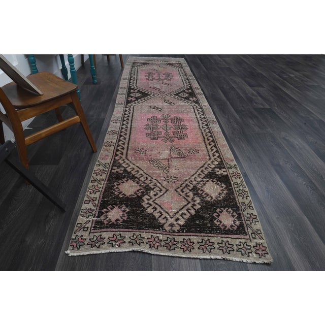 Vintage Hand-Knotted runner rug is a semi-antique vintage runner rug. The '70s Eastern region of Anatolia's unique rug is...