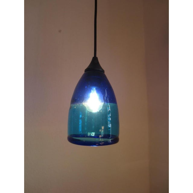 Intensely vibrant colors in blue and turquoise, with its distinctive Italian design, make this small Murano ceiling lamp a...