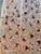 Hand-embroidered Suzani panel from Uzbekistan — multicoloured pomegranate buds in plum, rose and gold scattered across an...