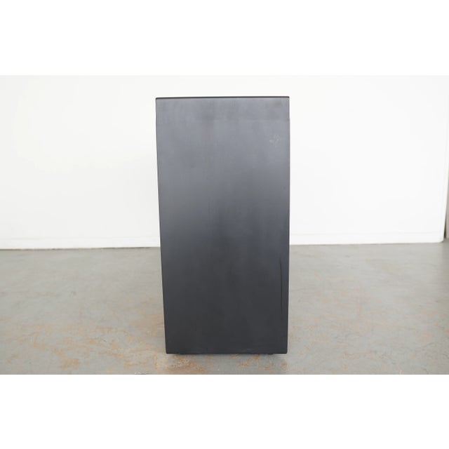 Geometric angles, super sleek lines and a deep ebony finish make this a standout console. The light catches angled planes...