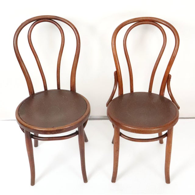 Pair of similar style beech bentwood bistro chairs. One is an authentic Thonet, and the other is Fischel made in the...