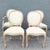A charming set of four vintage French Provincial dining chairs, featuring three side chairs and one captain’s chair with...