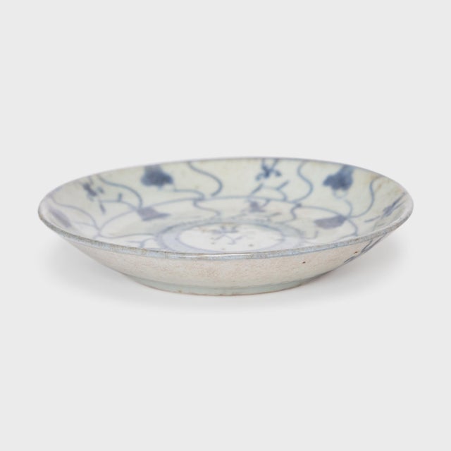 This 19th-century porcelain plate is hand-painted with cobalt underglaze in the blue-and-white manner, loosely brushed...