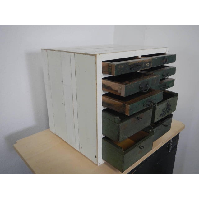 Made of fir wood and lined with reclaimed wood. It features 10 drawers of various sizes. The 6 upper drawers are...