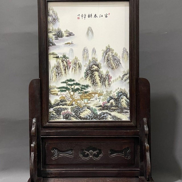 This is a magnificent and monumental vintage Chinese Rosewood Screen featuring a large, hand-painted Famille Rose...