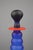 Striking blown-glass bottle with a strong Postmodern design influence. Its bold, tiered silhouette in frosted cobalt-blue...