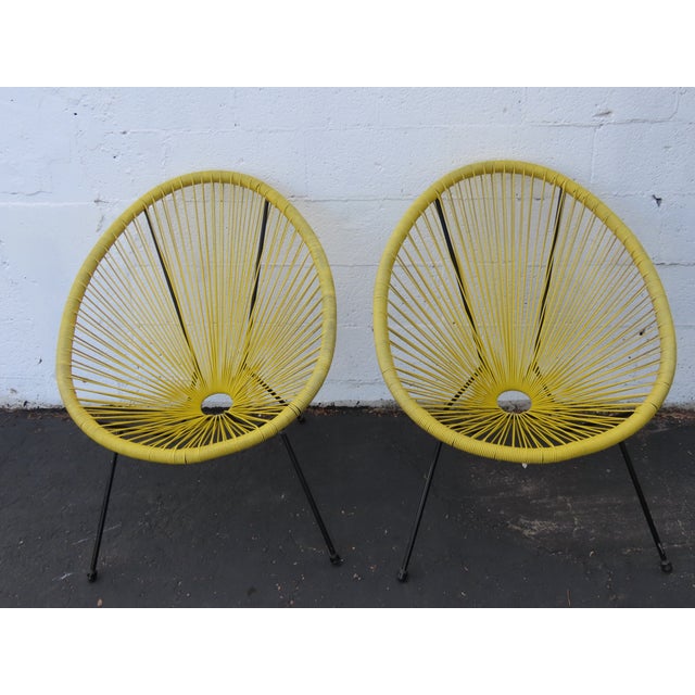 Add a vibrant retro touch to your indoor or outdoor space with this matching pair of Acapulco-style lounge chairs....