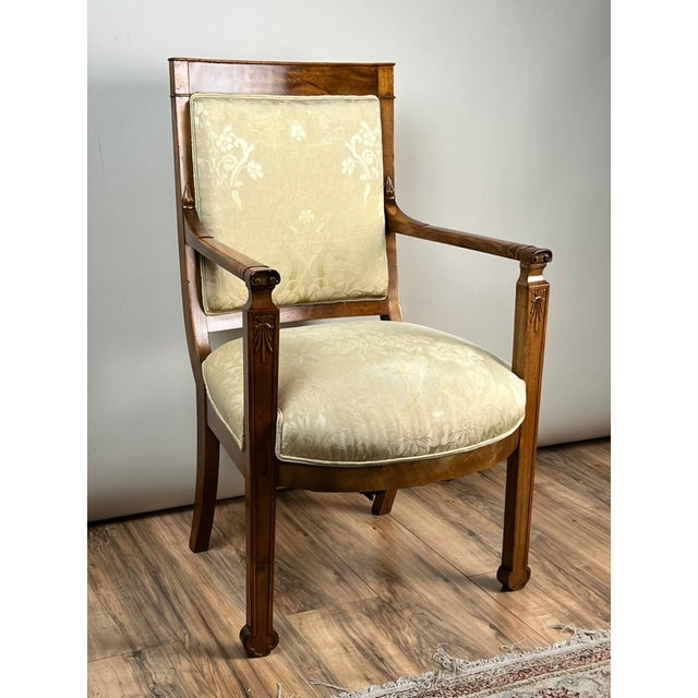 This elegant antique French fauteuil reflects the restrained sophistication of the Directoire period, with clean...