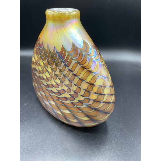 Great colors, golden background with iridescent feathers throughout body of the vase! Amber sunset colors.. marked on...
