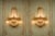 This decorative pair of French wall sconces dates to approximately 1980 and combines classical Louis XVI styling with a...